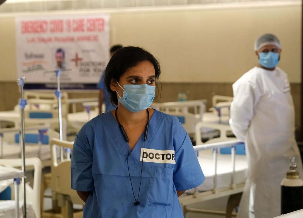 A doctor stands in a makeshift ward at an emergency Covid-19 care center (Photographer T. Narayan/Bloomberg)
